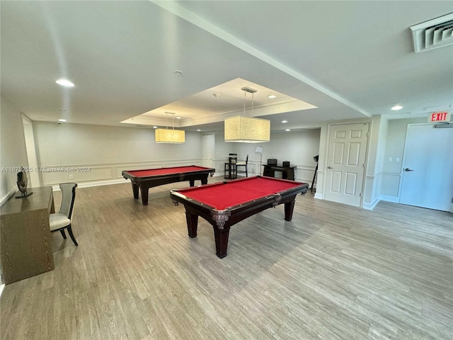 game room with a raised ceiling, hardwood / wood-style flooring, and billiards