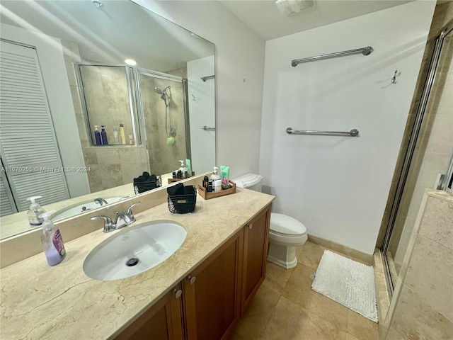 bathroom with tile patterned flooring, walk in shower, vanity, and toilet