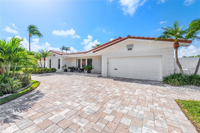 mediterranean / spanish house featuring a garage