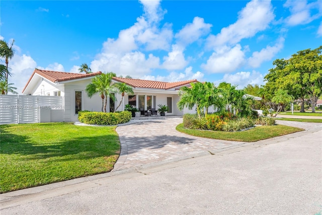 mediterranean / spanish-style home with a front lawn