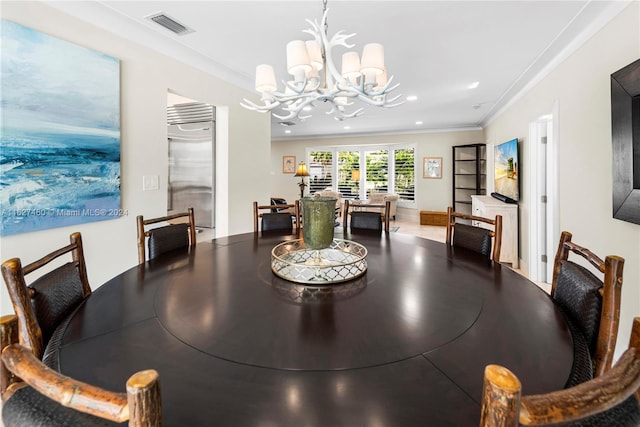 dining room with crown molding and a chandelier