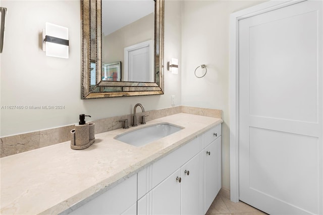 bathroom featuring tile patterned flooring and vanity