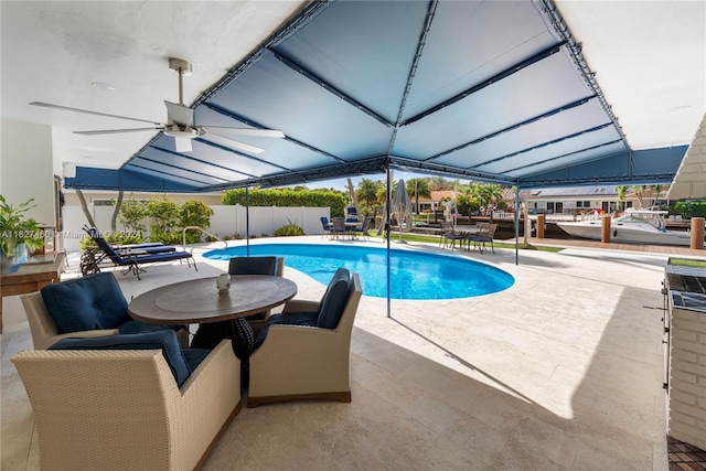 view of pool with ceiling fan and a patio