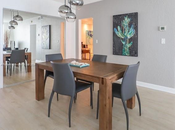 dining area featuring light wood-type flooring