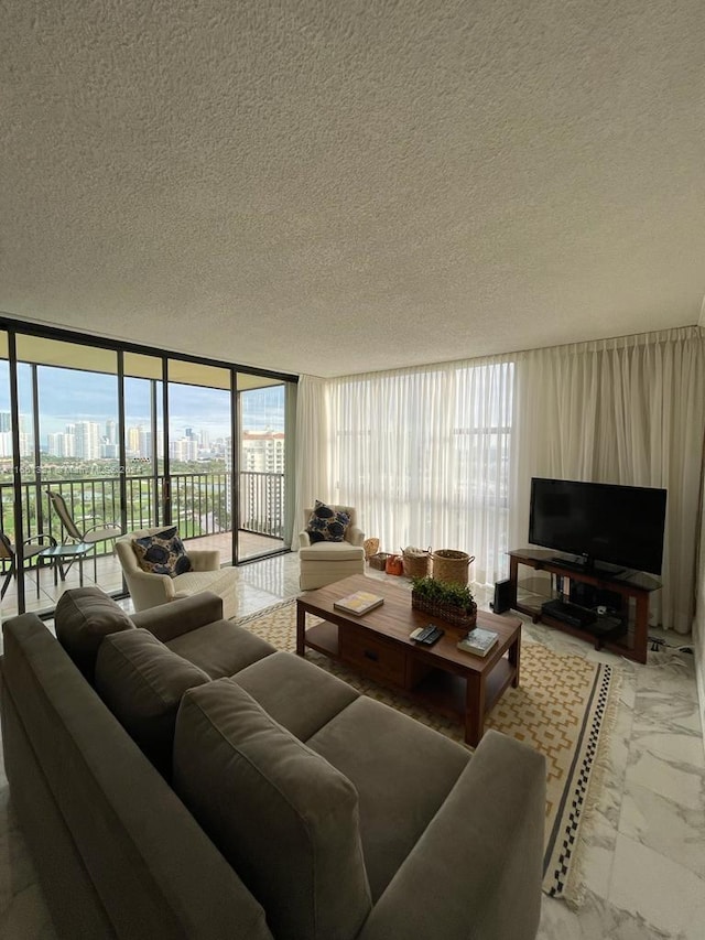 living room featuring a textured ceiling and floor to ceiling windows