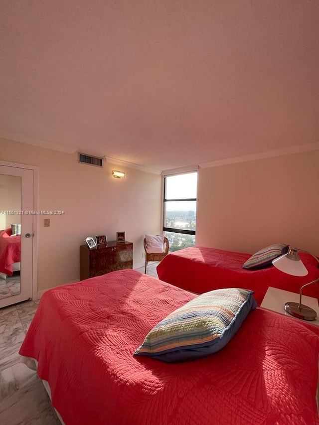 bedroom with ornamental molding