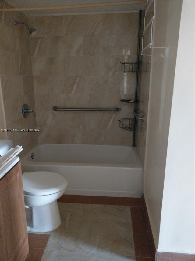 full bathroom with vanity, tiled shower / bath combo, toilet, and tile patterned flooring