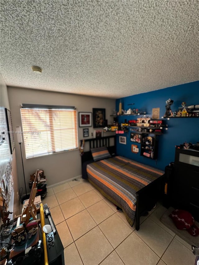 tiled bedroom featuring a textured ceiling