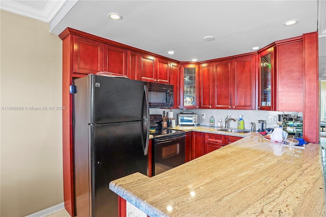 kitchen featuring black appliances, decorative backsplash, crown molding, and sink