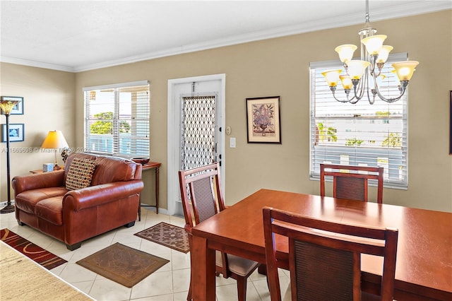 dining area with a notable chandelier, crown molding, and light tile patterned floors