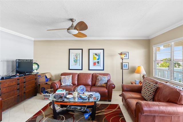 tiled living room with ceiling fan, a textured ceiling, and ornamental molding