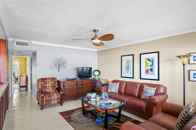 living room featuring ornamental molding, ceiling fan, light tile patterned flooring, and a textured ceiling