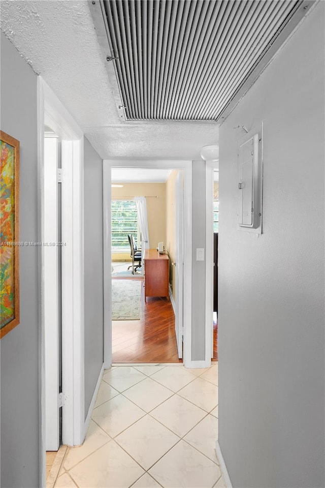 hallway featuring light hardwood / wood-style flooring and electric panel