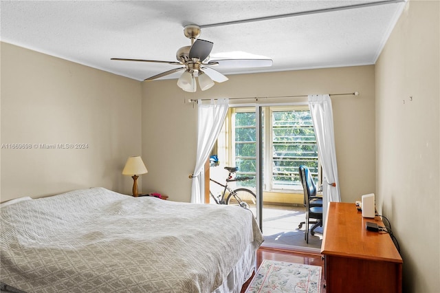 bedroom featuring ceiling fan, hardwood / wood-style flooring, crown molding, and a textured ceiling