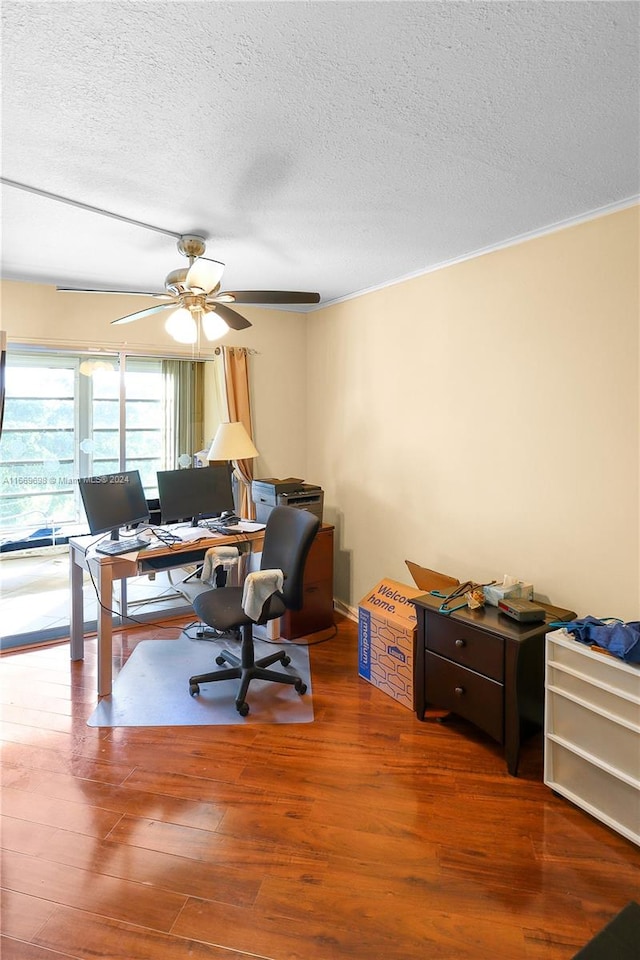 office area with a textured ceiling, hardwood / wood-style floors, and ceiling fan