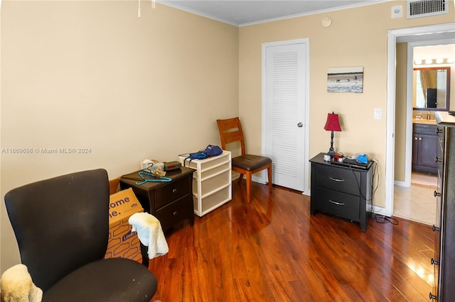 sitting room with ornamental molding, sink, and dark hardwood / wood-style flooring