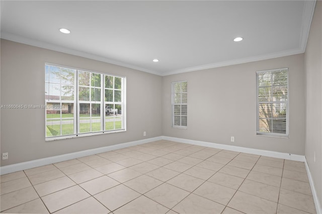 spare room with light tile patterned flooring, a healthy amount of sunlight, and crown molding