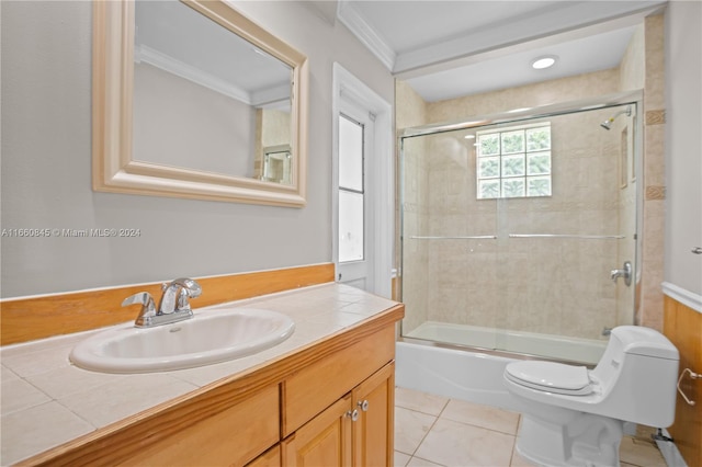 full bathroom featuring combined bath / shower with glass door, tile patterned floors, ornamental molding, vanity, and toilet