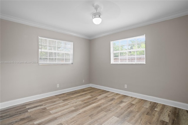 unfurnished room with ornamental molding, ceiling fan, light hardwood / wood-style floors, and a healthy amount of sunlight