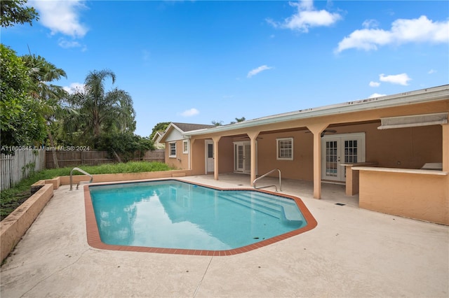 view of pool featuring a patio and french doors