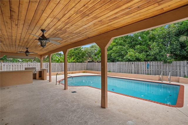 view of pool with ceiling fan and a patio