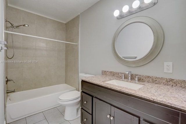 full bathroom with tile patterned floors, tiled shower / bath, vanity, and toilet