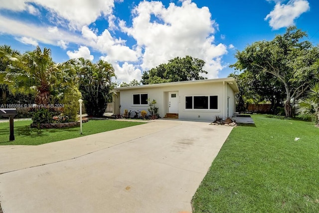 ranch-style home featuring a front yard