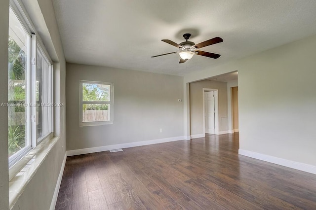 unfurnished room with ceiling fan, dark hardwood / wood-style floors, and a textured ceiling