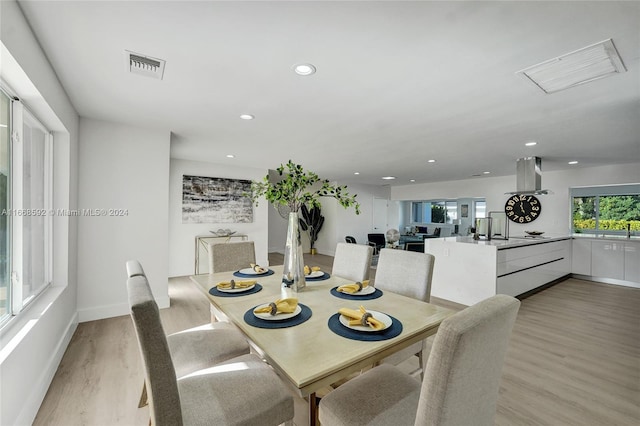 dining space with light hardwood / wood-style flooring