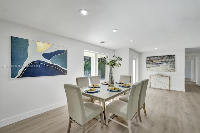 dining space featuring light wood-type flooring