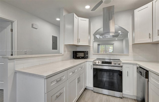 kitchen with ventilation hood, ceiling fan, stainless steel appliances, and white cabinets