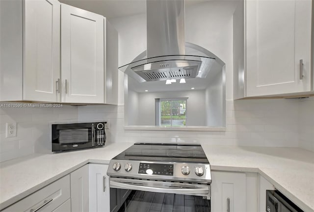 kitchen featuring decorative backsplash, white cabinets, stainless steel range with electric stovetop, light stone countertops, and exhaust hood