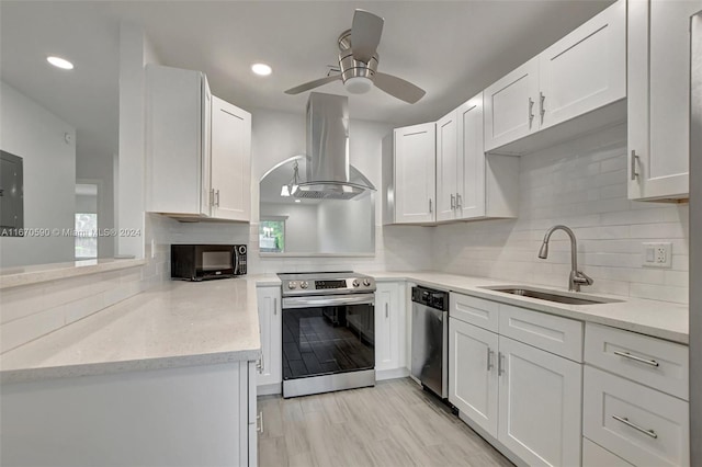 kitchen with light wood-type flooring, sink, ventilation hood, white cabinets, and stainless steel appliances