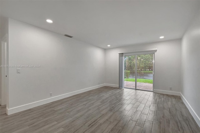 empty room with hardwood / wood-style flooring