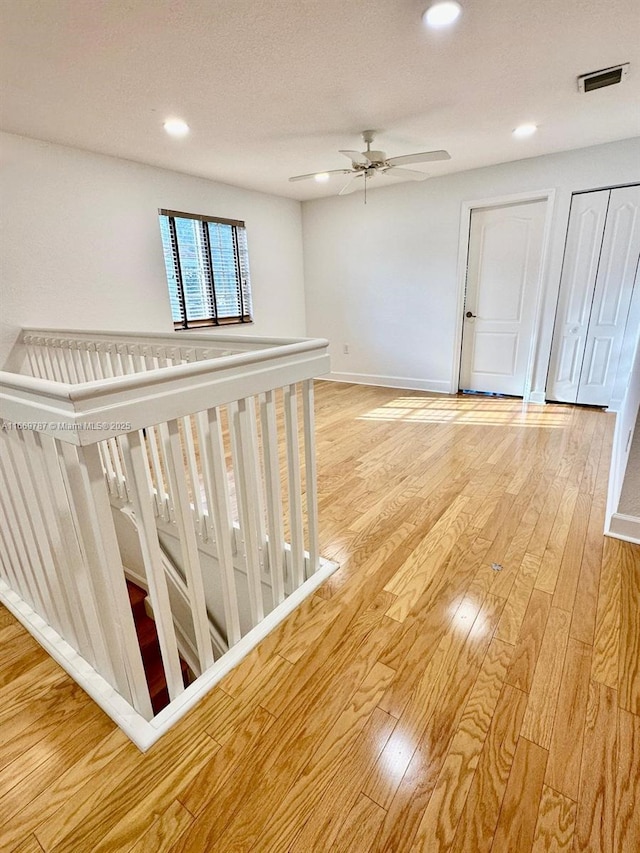 interior space with a textured ceiling and light hardwood / wood-style flooring