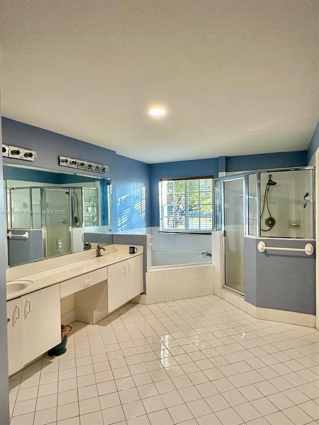 bathroom with tile patterned flooring, vanity, and plus walk in shower