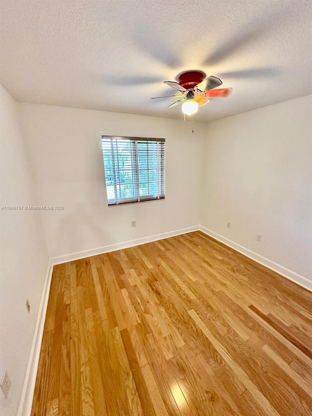 unfurnished room featuring wood-type flooring, ceiling fan, and a textured ceiling