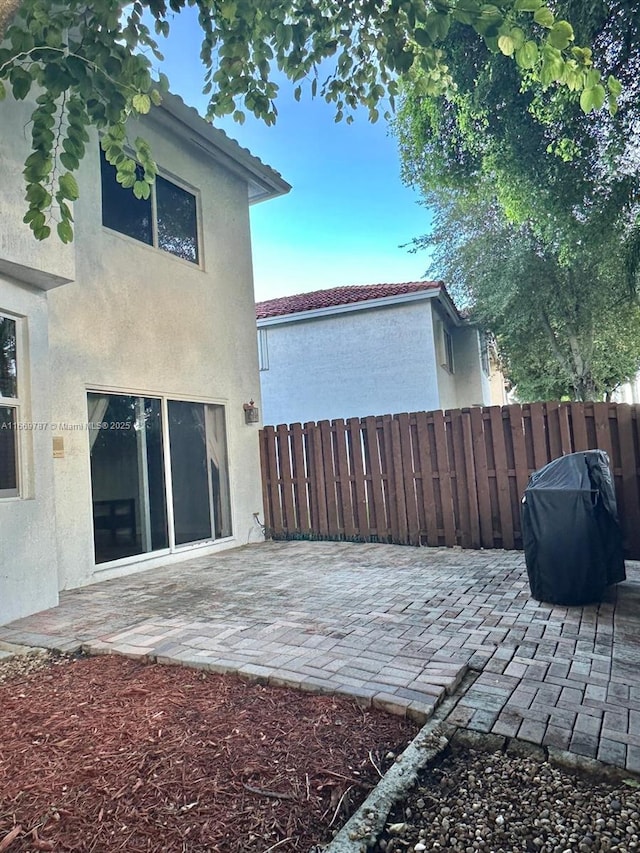 back of property with a patio