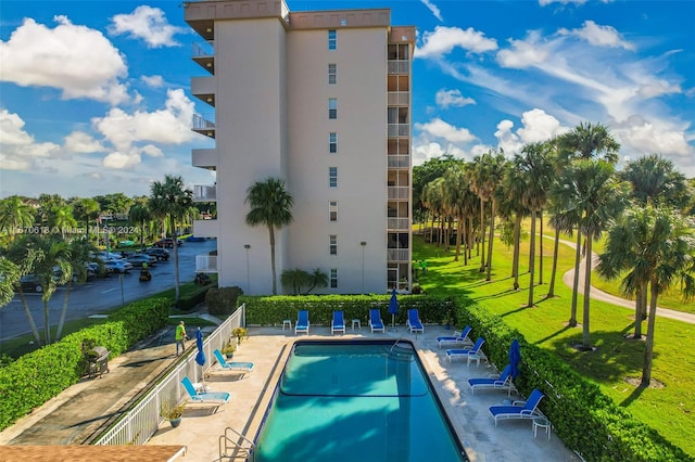 view of pool featuring a lawn