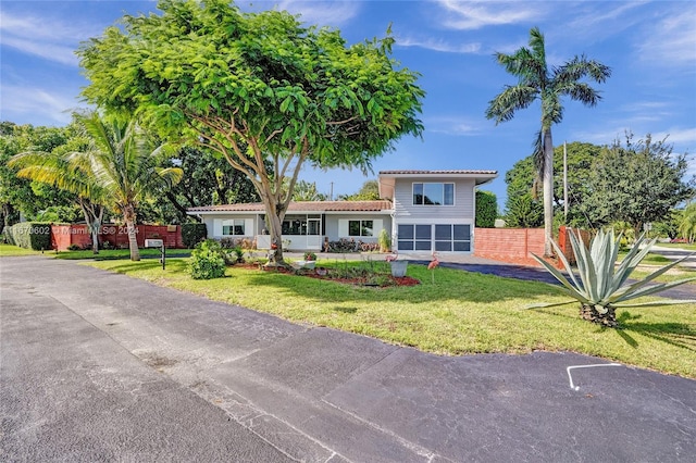 view of front of property featuring a garage and a front lawn