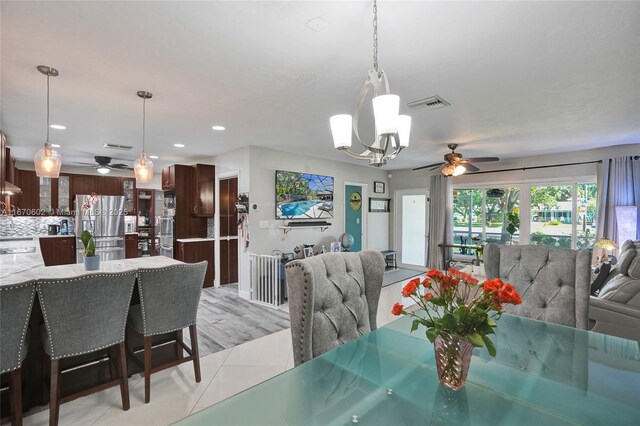 living room with ceiling fan and light tile patterned floors