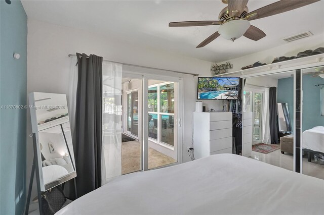 bedroom featuring multiple windows, access to exterior, and ceiling fan