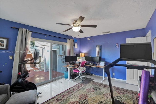 office space featuring light tile patterned flooring, ceiling fan, and a textured ceiling