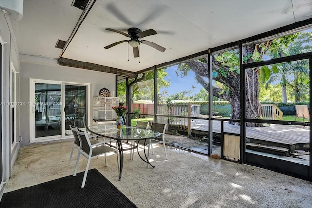 sunroom featuring ceiling fan