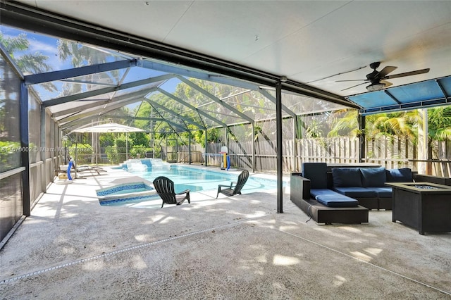 view of swimming pool with outdoor lounge area, a patio, and glass enclosure