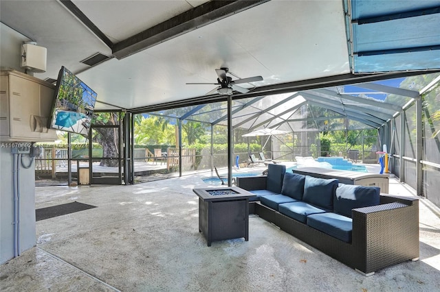 view of patio featuring a fenced in pool, glass enclosure, and an outdoor living space with a fire pit