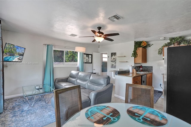 tiled dining room featuring sink and ceiling fan