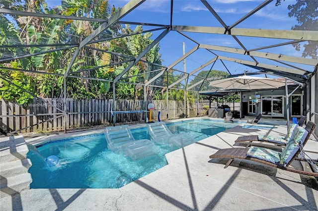 view of pool featuring pool water feature, a lanai, and a patio