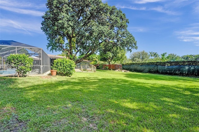 view of yard with glass enclosure