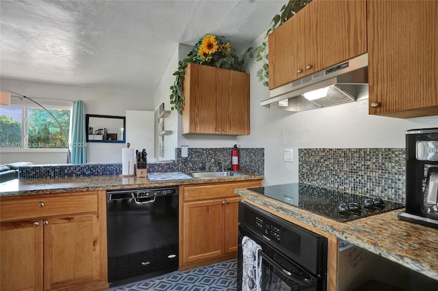 kitchen with black appliances, sink, light stone counters, and backsplash